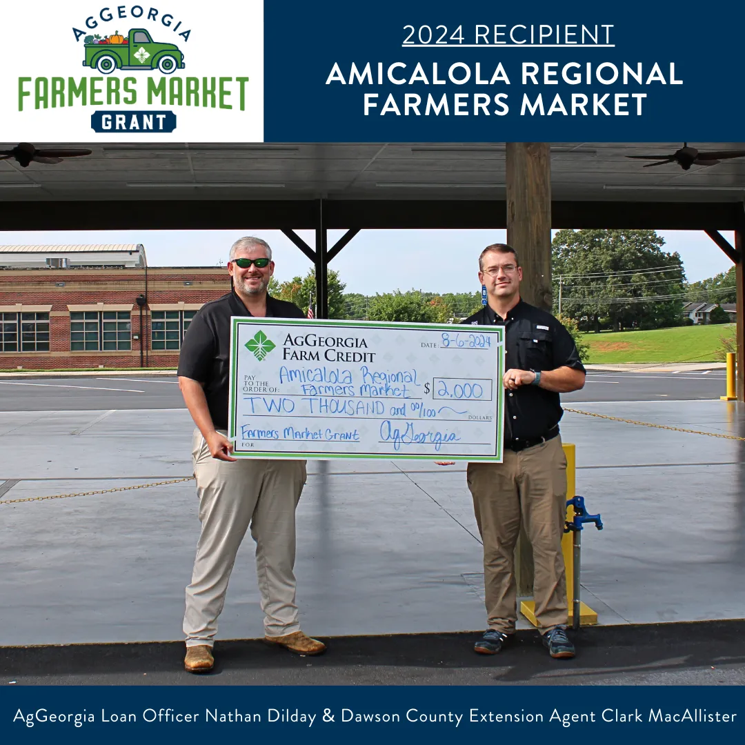 Two people holding a large check.