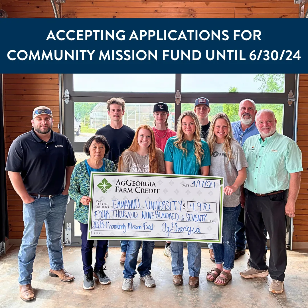 Group of people smiling and holding a big check.