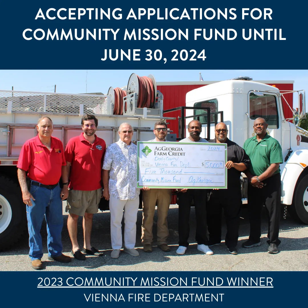 Group of people smiling and holding a big check.