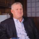 Man in a collared shirt and suit jacket.